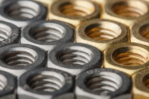Metallic hex nuts layed out in a hexagonal pattern Stock Photos