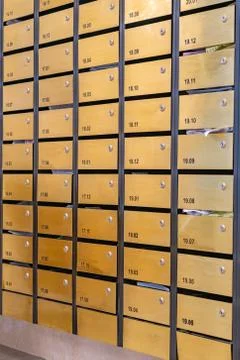 Metallic letter mailbox array at condominium entrance hall Foto stock