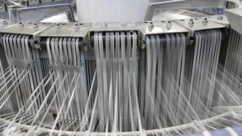 Metallic machines with fluctuating plastic ropes connected with a high column Stock-Footage 128674010