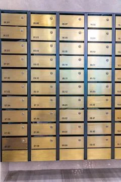 Metallic mailbox array in lobby of condominium building Foto stock