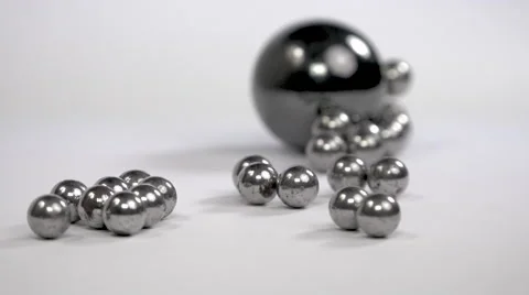 Metallic marbles and rolling magnet ball on white background - close up Stock Footage 58040190