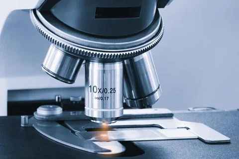 Metallic microscope objective lens close-up. Sharp focus on mechanical detail Фото
