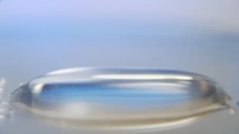 Metallic needle approaching and taking medical liquid from a small pool in a lab Stock-Footage 127216165