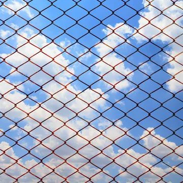 Metallic net on blue sky background Stock Photos