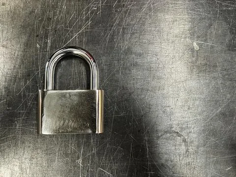 Metallic padlock on metal texture background Stock Photos