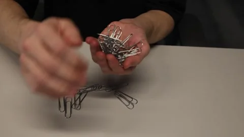 Metallic paper clips used in the office 動画素材 345727347