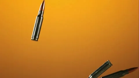 Metallic rifle bullets falling through the air Stock Footage 327120852