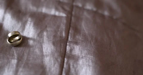 Metallic ring on brown leather surface in warm close-up Stock-Footage 336469163