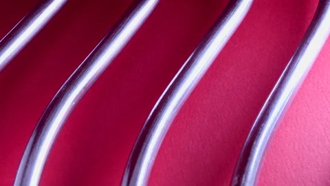 Metallic rods with shadows on dark red background Stock Footage 251151493