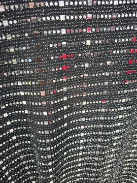 Metallic sequin knit texture with reflective elements perfect for fashion d.. Stock Photos