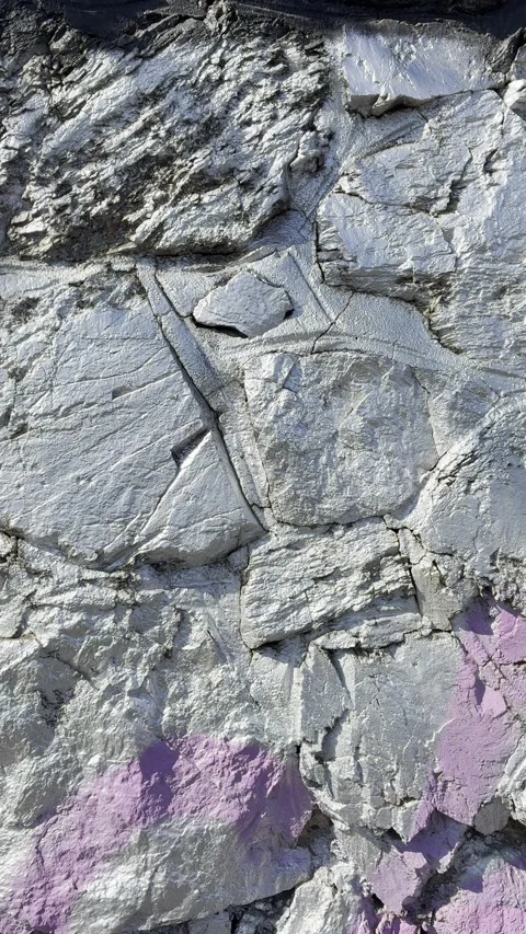 Metallic Silver Spray Paint on Textured Rock Wall Stock Footage 336343729