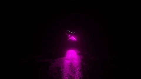 Metallic silvery rings of different sizes rotate in a purple glow on a dark meta Video stock 163749582