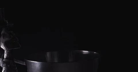Metallic skeleton wearing a top hat rotates in darkness Stock Footage 117350758