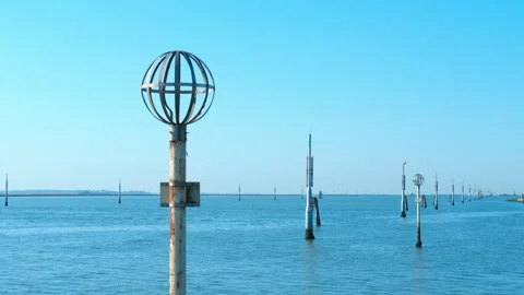 Metallic spherical navigation buoy and channel markers in venice lagoon Stock Footage 317222778
