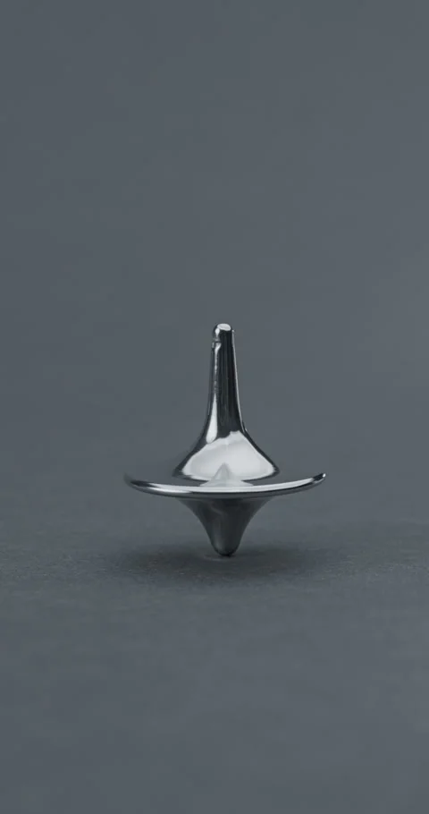 Metallic Spinning Top Falling Over. Video stock 329606872