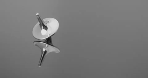 Metallic Spinning Top Falling Over.  Stock Footage 335638612