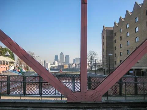 Metallic structure bridge over river and a view between pillars at the skyscr Stock Photos