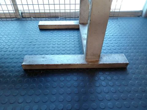 Metallic Support Structure on Textured Floor Foto stock