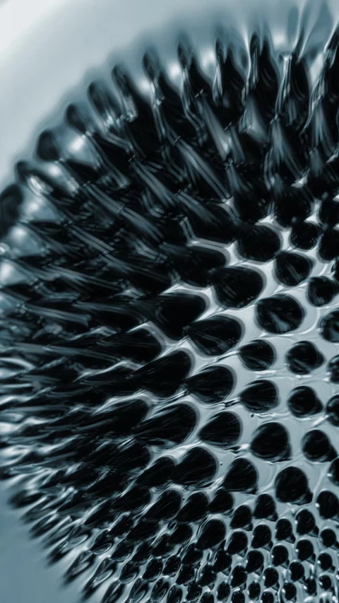 Metallic surface evolves through radial patterns and soft distortion Stock Footage 344978887