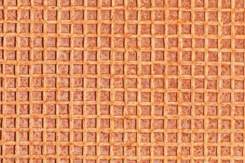 Metallic surface marked by heavy rust in square pattern 库存照片