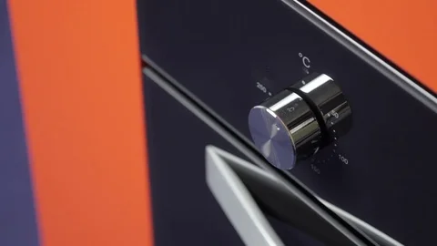 Metallic Toggle Switch of the Cooker Oven. Close-up View. Digital Clock of oven. Stock Footage 84830633