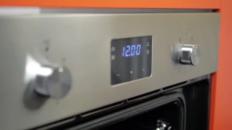 Metallic Toggle Switch of the Cooker Oven. Close-up View. Digital Clock of oven. Stock Footage 84830689