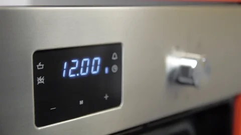 Metallic Toggle Switch of the Cooker Oven. Close-up View. Digital Clock of oven. Stock Footage 84830707