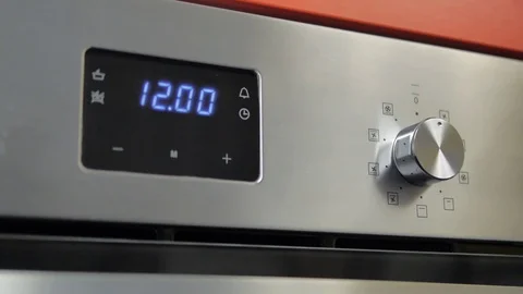 Metallic Toggle Switch of the Cooker Oven. Close-up View. Digital Clock of oven. Stock Footage 84830718