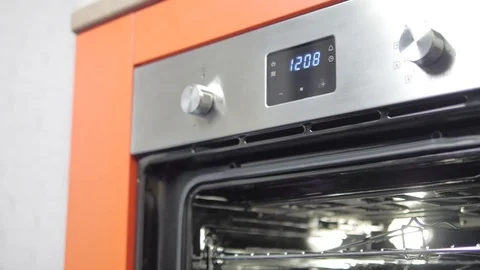 Metallic Toggle Switch of the Cooker Oven. Close-up View. Digital Clock of oven. Stock Footage 84830736
