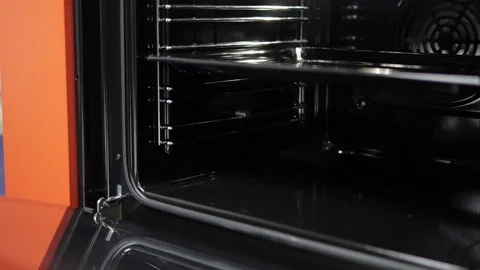 Metallic Toggle Switch of the Cooker Oven. Close-up View. Digital Clock of oven. Stock Footage 84830740