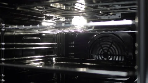 Metallic Toggle Switch of the Cooker Oven. Close-up View. Digital Clock of oven. Stock Footage 84830771