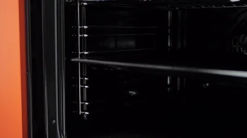 Metallic Toggle Switch of the Cooker Oven. Close-up View. Digital Clock of oven. Stock Footage 84830841