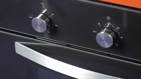 Metallic Toggle Switch of the Cooker Oven. Close-up View. Digital Clock of oven. Stock Footage 84830853