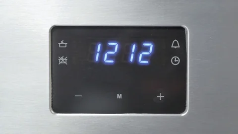 Metallic Toggle Switch of the Cooker Oven. Close-up View. Digital Clock of oven. Stock Footage 84830877