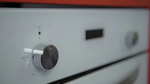 Metallic Toggle Switch of the Cooker Oven. Close-up View. Digital Clock of oven. Stock Footage 84830973