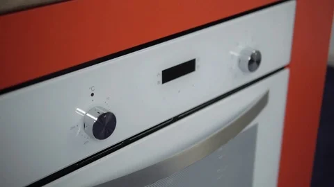 Metallic Toggle Switch of the Cooker Oven. Close-up View. Digital Clock of oven. Stock Footage 84830977