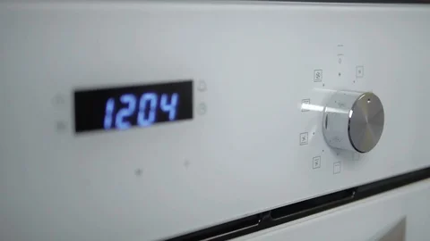 Metallic Toggle Switch of the Cooker Oven. Close-up View. Digital Clock of oven. Stock Footage 84830987