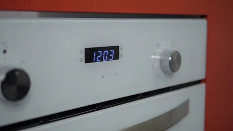 Metallic Toggle Switch of the Cooker Oven. Close-up View. Digital Clock of oven. Stock Footage 84830988