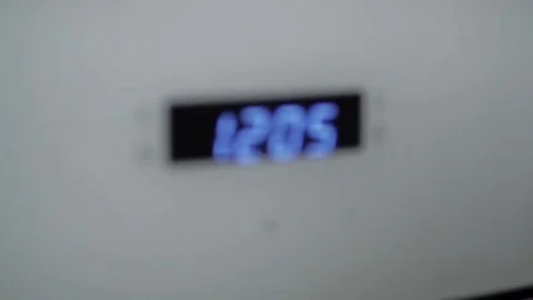 Metallic Toggle Switch of the Cooker Oven. Close-up View. Digital Clock of oven. Stock Footage 84830997