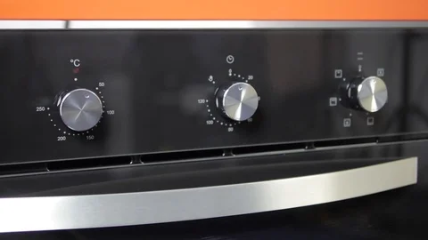 Metallic Toggle Switch of the Cooker Oven. Close-up View. Digital Clock of oven. Stock Footage 84831159