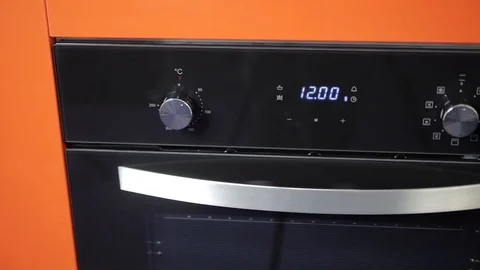 Metallic Toggle Switch of the Cooker Oven. Close-up View. Digital Clock of oven. Stock Footage 84831198