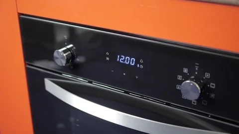 Metallic Toggle Switch of the Cooker Oven. Close-up View. Digital Clock of oven. Stock Footage 84831283