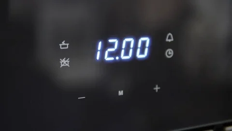 Metallic Toggle Switch of the Cooker Oven. Close-up View. Digital Clock of oven. Stock Footage 84831379