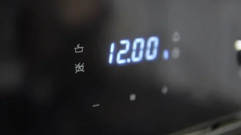 Metallic Toggle Switch of the Cooker Oven. Close-up View. Digital Clock of oven. Stock Footage 84831411