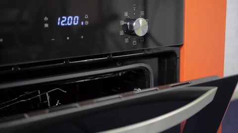 Metallic Toggle Switch of the Cooker Oven. Close-up View. Digital Clock of oven. Stock Footage 84831529