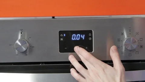 Metallic Toggle Switch of the Cooker Oven. Close-up View. Digital Clock of oven. Stock Footage 84831559