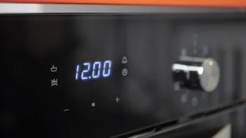 Metallic Toggle Switch of the Cooker Oven. Close-up View. Digital Clock of oven. Stock Footage 84831670