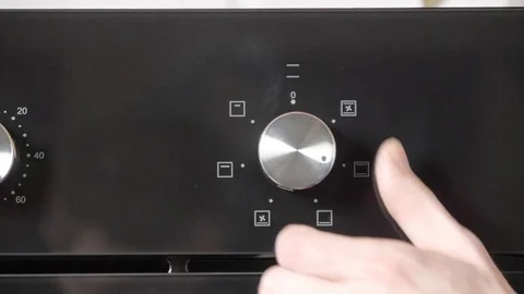 Metallic Toggle Switch of the Cooker Oven. Close-up View. Digital Clock of oven. Stock Footage 84831836