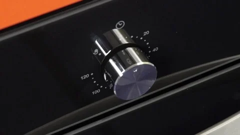 Metallic Toggle Switch of the Cooker Oven. Close-up View. Digital Clock of oven. Stock Footage 84831862