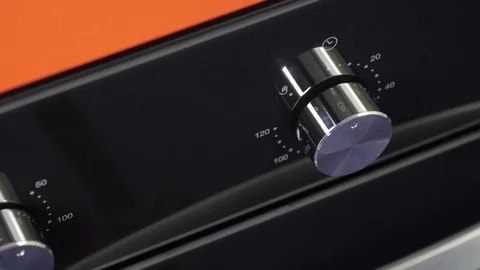 Metallic Toggle Switch of the Cooker Oven. Close-up View. Digital Clock of oven. Stock Footage 84831901